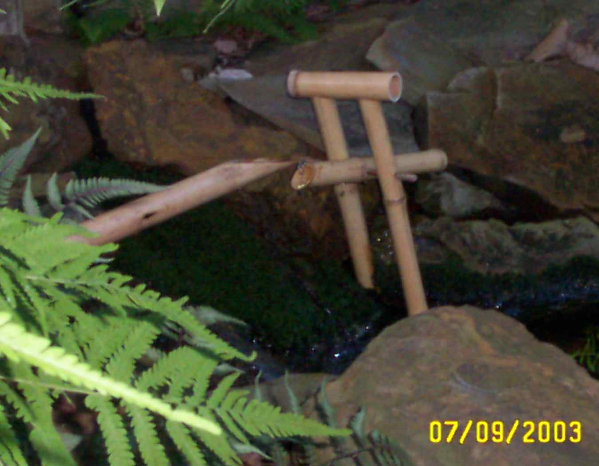 Bamboo shishi odoshi by the rocks