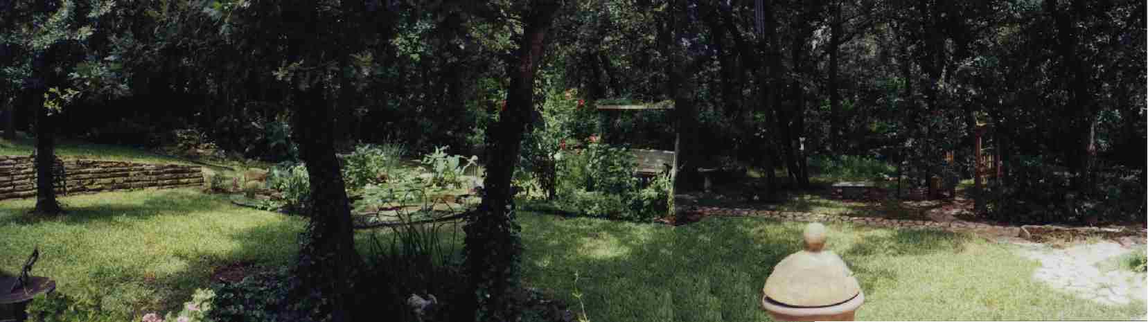 Panoramic view of the finished pond and backyard